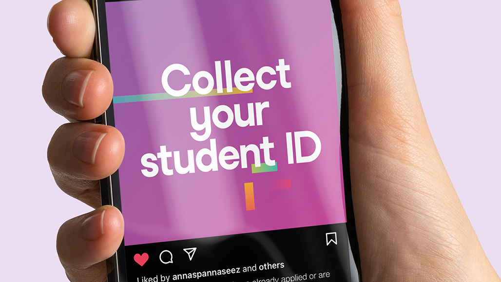 hand holding an iPhone, displaying a social media post by the university of hertfordshire